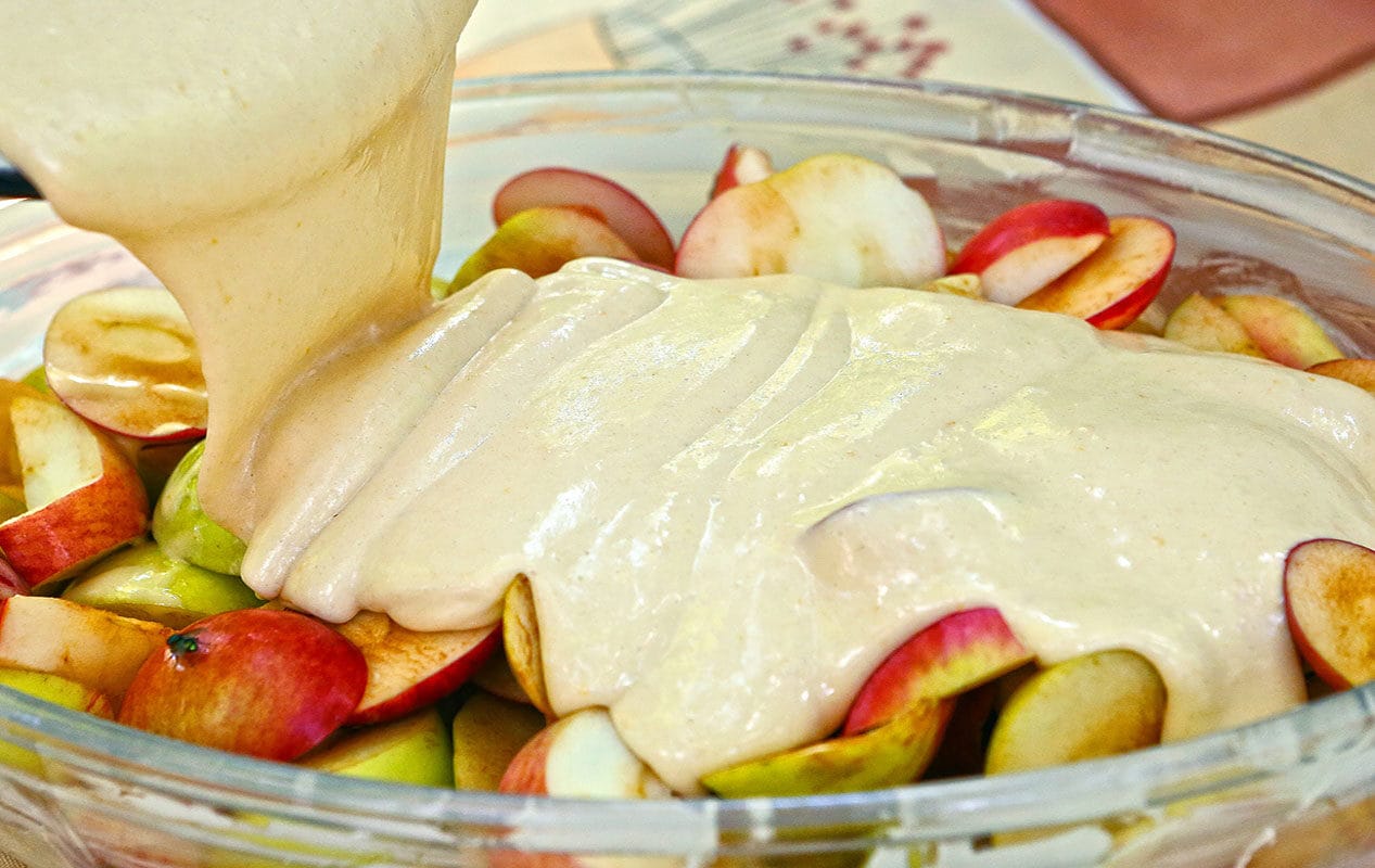 apple-pie-cooking-with-cut-apples-layer-filling-and-liquid-dough-2